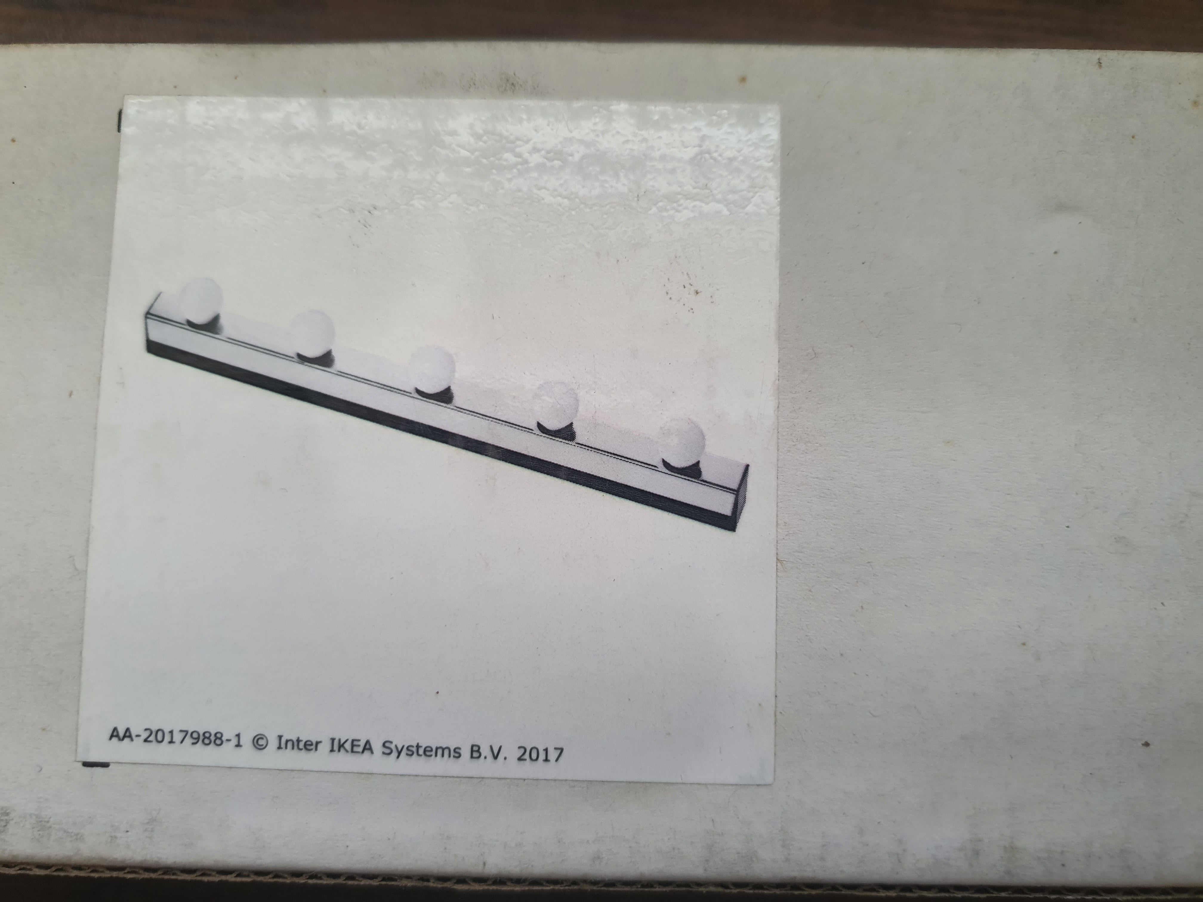 IKEA light fixture packaging with product illustration on a white background